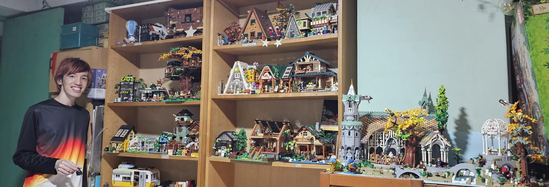 A founder smiling beside wooden shelves of lit brick builds, with a cabin village and a white gazebo
