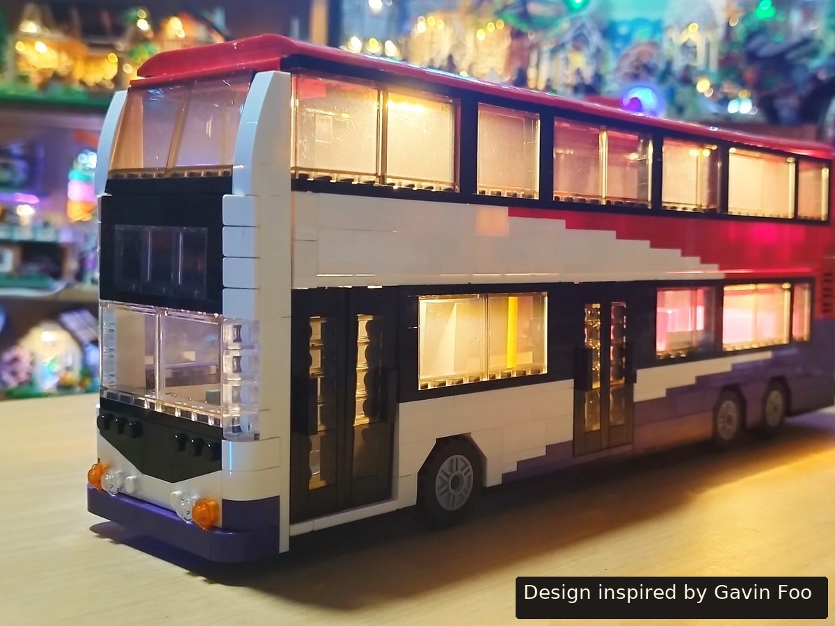 The double-decker SBS Transit bus, lit from inside, seen from the front left